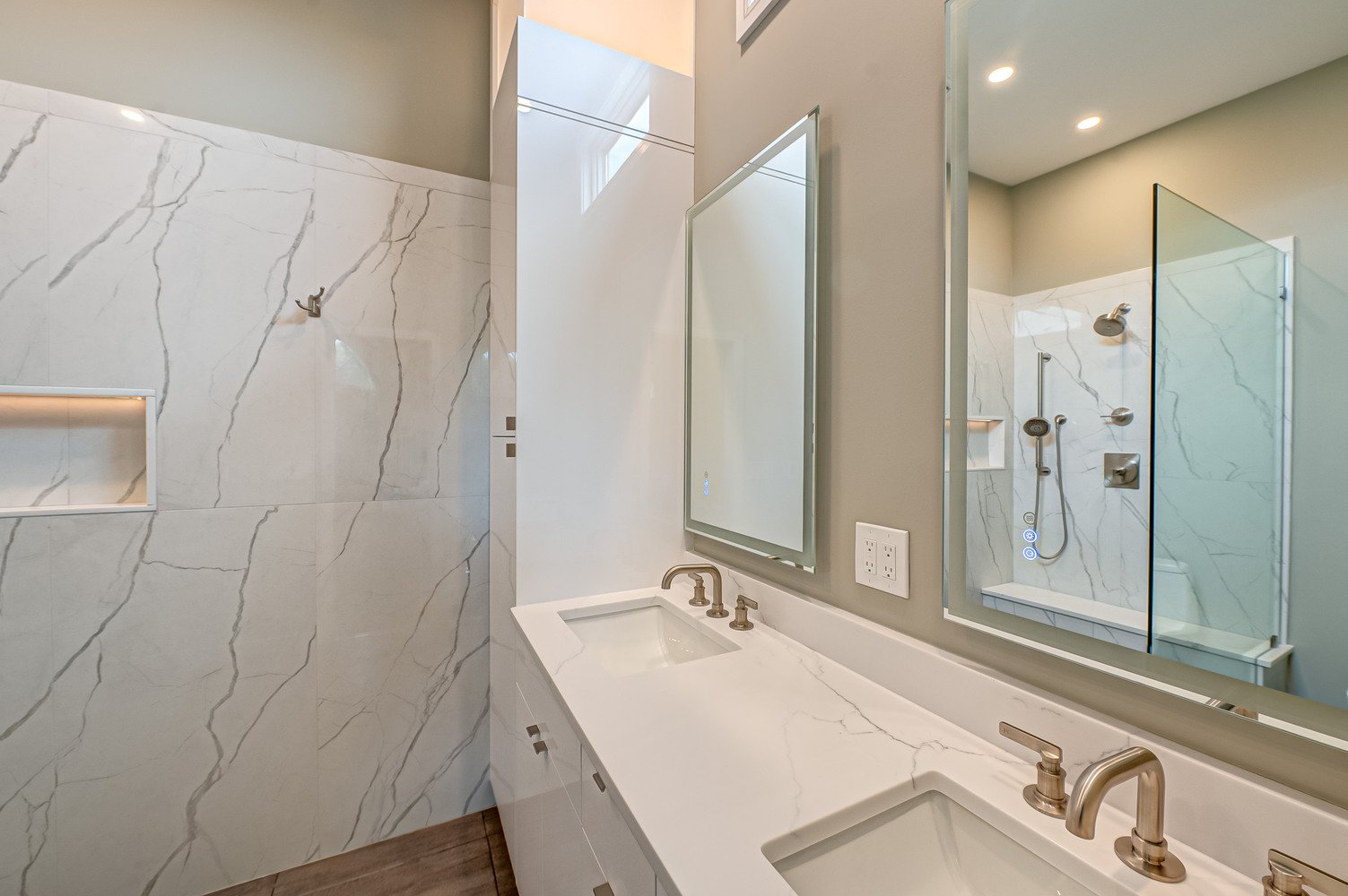 Double sink vanity with quartz countertop and LED mirrors in Suffolk County custom bathroom
