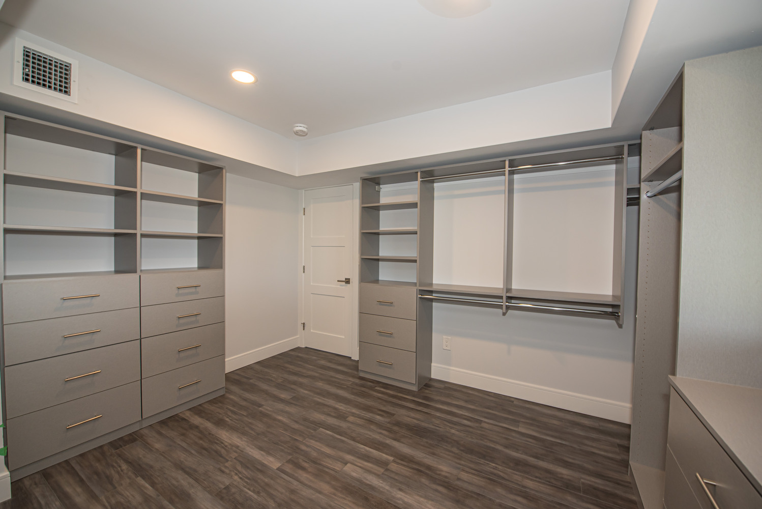 Organized closet space with built-in drawers in Mount Sinai, NY by Long Island Creative Contracting, Inc